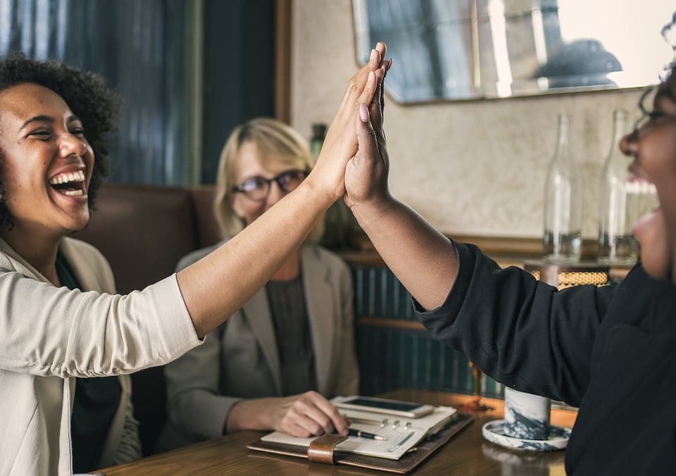 Two people raised their hands together and exchanged a high five.